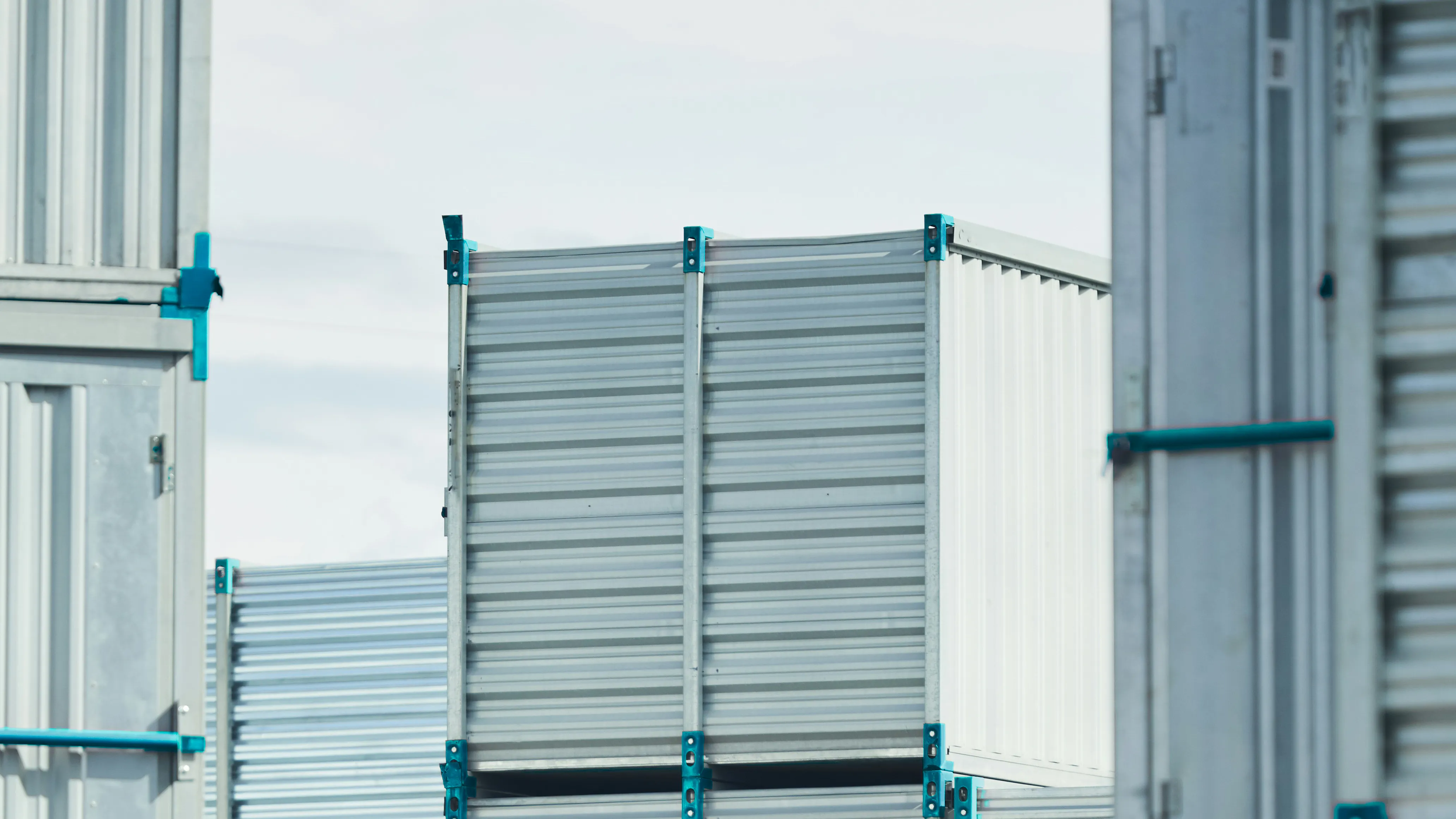 GREY FREIGHT CONTAINERS WITH BLUE CORNERS.
