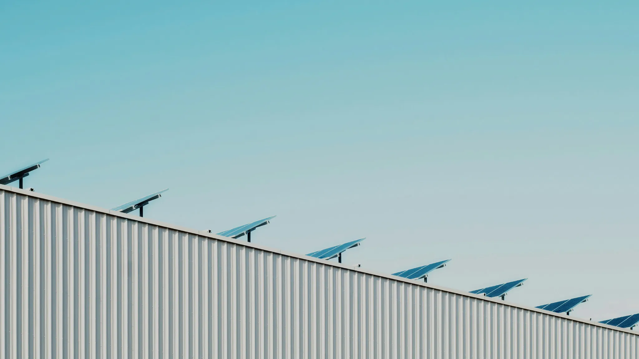 HALL ROOF WITH SOLAR PANELS AND BLUE SKY